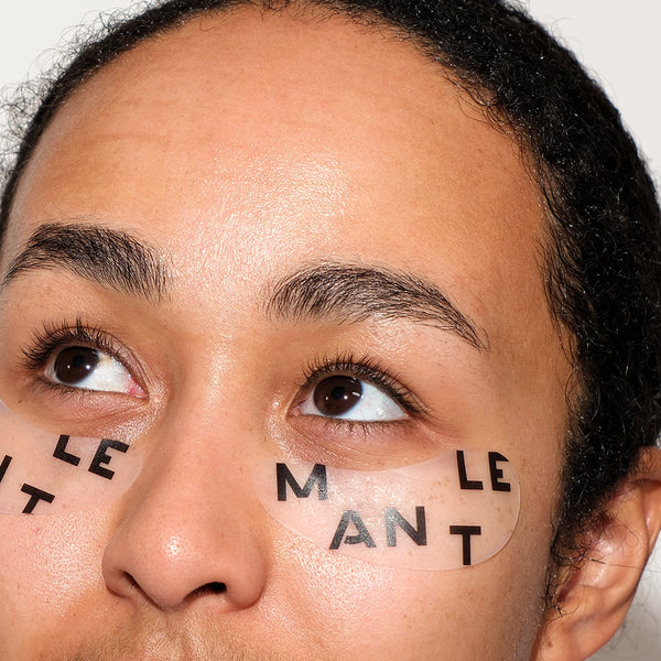 Model wearing reusable silicone under-eye patches from MANTLE