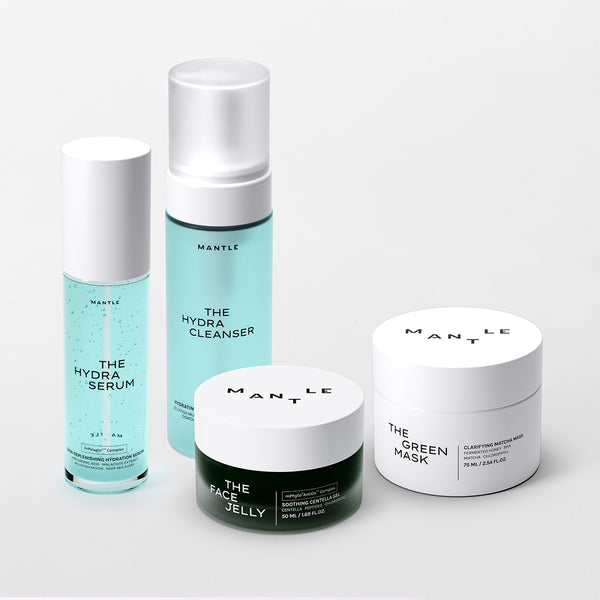 Set of skincare products including serum, cleanser, gel moisturiser, and face mask from MANTLE